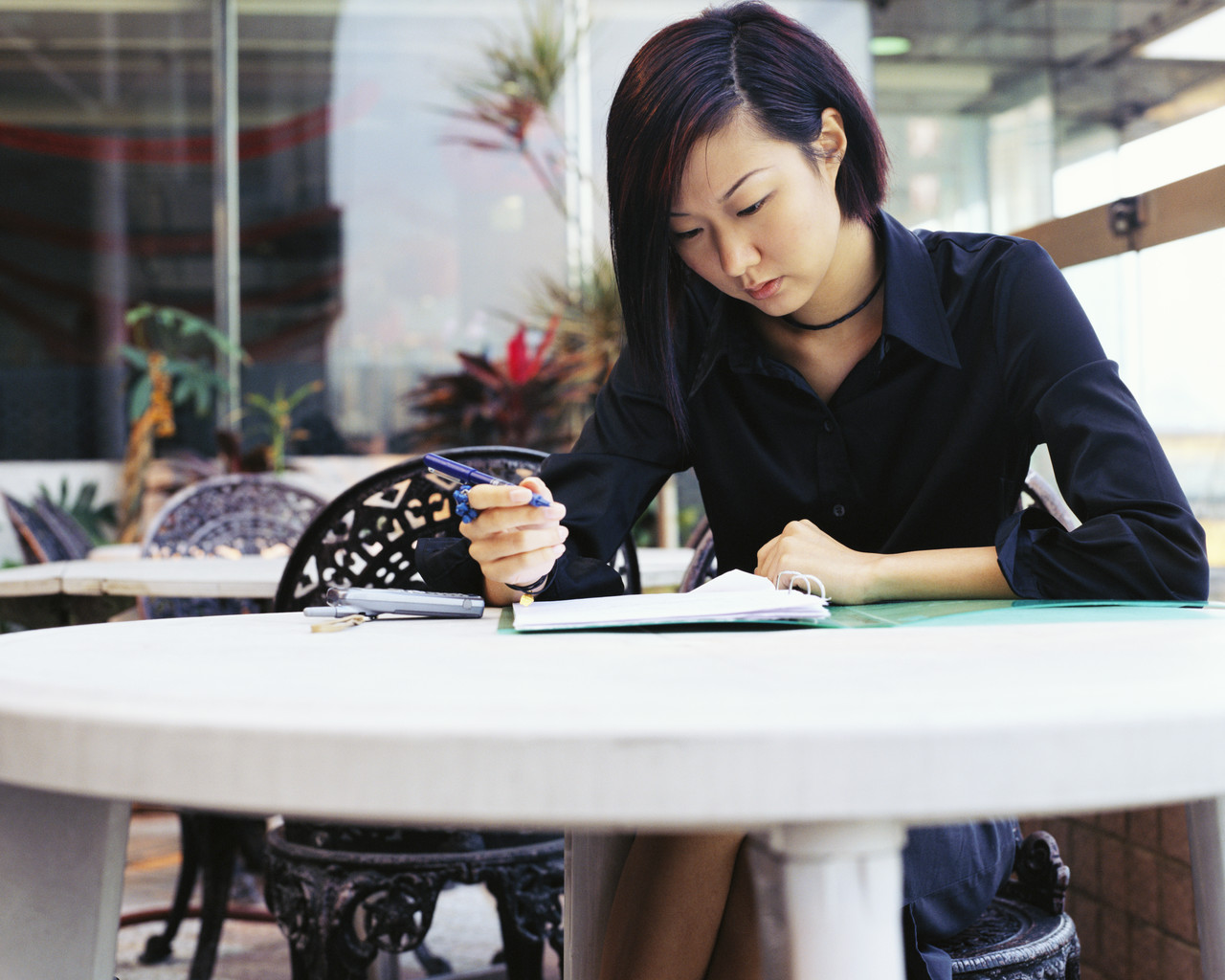 Stock photo of woman writing at table